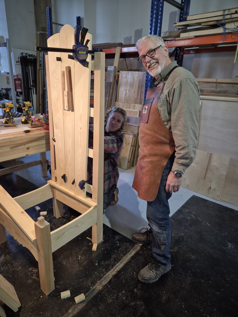 Members work together on the reading chair2